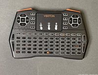 Front view of Viboton i8 Plus keyboard showing keys, touchpad and controls