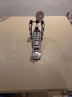 Front view of bass drum pedal showing footboard and beater