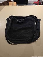 Front view showing mesh pocket and zipper