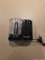 Left side view showing motor housing, clear bowl, blade and power cord