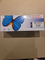 Front of sealed CBP-CF217A toner cartridge box showing model and compatibility