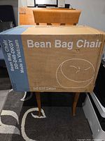Cardboard carton showing Bean Bag Chair branding and model