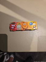 Front of one sealed 3-pack sleeve showing Crayola Silly Scents Dough branding and fruit characters