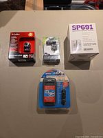 Group view of all four sealed electronic items
