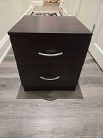Front view of nightstand showing two drawers and silver handles