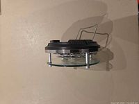 Side profile showing glass face, gears, metal standoffs, wire stand