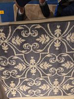 Angle view of mat illustrating grey and white scroll pattern