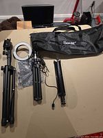 Overview of kit showing both tripods, ring light, accessory pack, and carry bag