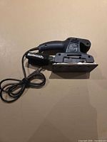 Side view of Mastercraft pad sander showing body, dust bag and cord