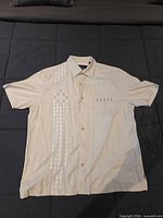 Front view of Nat Nast silk shirt laid flat
