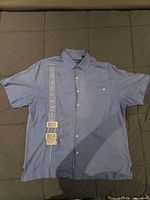 Front view of blue Nat Nast silk shirt with guitar motif