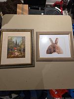 Both framed artworks side by side on table