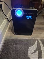 Front view showing LED humidity display and mist outlet