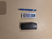 Front view of RCA RP5035A recorder, leather case, pen for scale