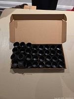 Open box showing quantity of rubber chair leg protectors