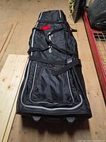 Front view of full bag showing soft nylon body, TaylorMade logo, exterior pocket, compression straps