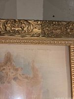 Close view of ornate gilt frame upper edge and glass