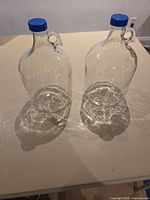 Both glass bottles standing upright showing overall form and caps