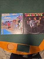 Front view of both record jackets on table