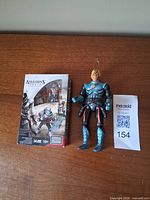 Mega Bloks sealed box beside loose action figure