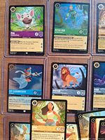Nine sleeved/top-loaded Disney Lorcana cards displayed in grid showing Pua, Peter Pan foil, Kit Cloudkicker, Mufasa, Kida and others