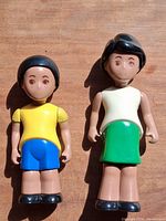 Front view of both Little People figures showing clothing colors and facial details