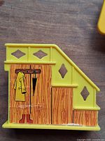 yellow staircase section with printed coat rack graphic