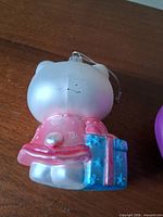 Rear view of Hello Kitty ornament showing paint wear and hanger string