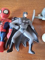 Group shot showing Spider-Man, Batman, Tom and generic figure, illustrating size, colours and wear.