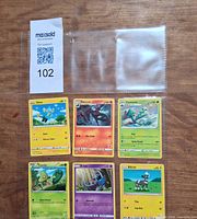 All six Pokémon cards in binder sleeve with MaxSold lot tag