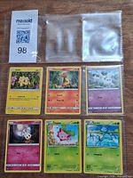 Front view of six Pokémon cards in 9-pocket sleeve