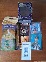 All items: Lorcana starter deck, Monster High boxed figure, Fortnite sleeved cards