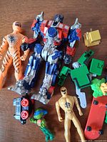 All toys laid out on wooden surface showing condition and components