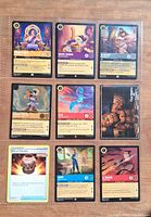 Nine trading cards displayed in 9-pocket sleeve (front view)
