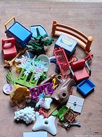 Grouped view of all Playmobil accessory parts spread on table