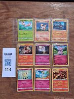 All nine Pokémon cards in binder sleeve with MaxSold tag visible