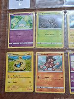 Front view showing four Pokémon cards (Hatenna, Scatterbug, Mareep, Mudbray) in binder page