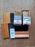 Group of five Ralph Lauren brushes; two boxed stipplers and three wood-handled rakes