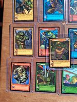 Fronts of multiple TMNT TCG cards in sleeves