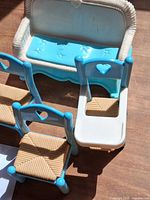 Cluster of loveseat, three blue chairs, one white-blue high chair