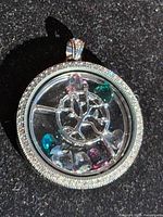 front view of pendant showing Tree of Life, pave border, multicolour heart crystals