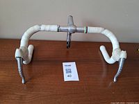 Complete handlebar assembly with stem, levers, white tape