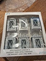 Factory-sealed box containing six white mini lanterns