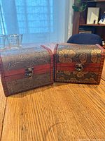 Front view of both floral embossed trinket boxes closed