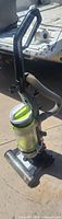 Full view of Bissell upright vacuum showing handle, hose and base