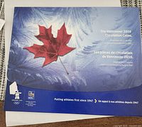 Front cover of RBC Vancouver 2010 coin booklet with maple leaf graphic