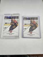 Front view of both Connor McDavid Young Stars cards in holders