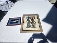 Both framed artworks laid out for size reference