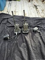 Front view of both radios on chargers with power adapters