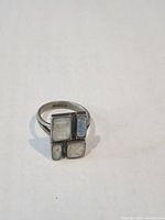 Front view showing four opal inlay panels and silver setting